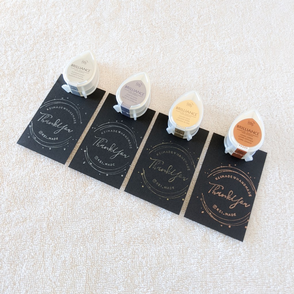 Here's what Tsukineko Brilliance metallic ink pads look like when stamped on black paper | ツキネコのブリリアンスメタリックスタンプを黒い紙に押してみた