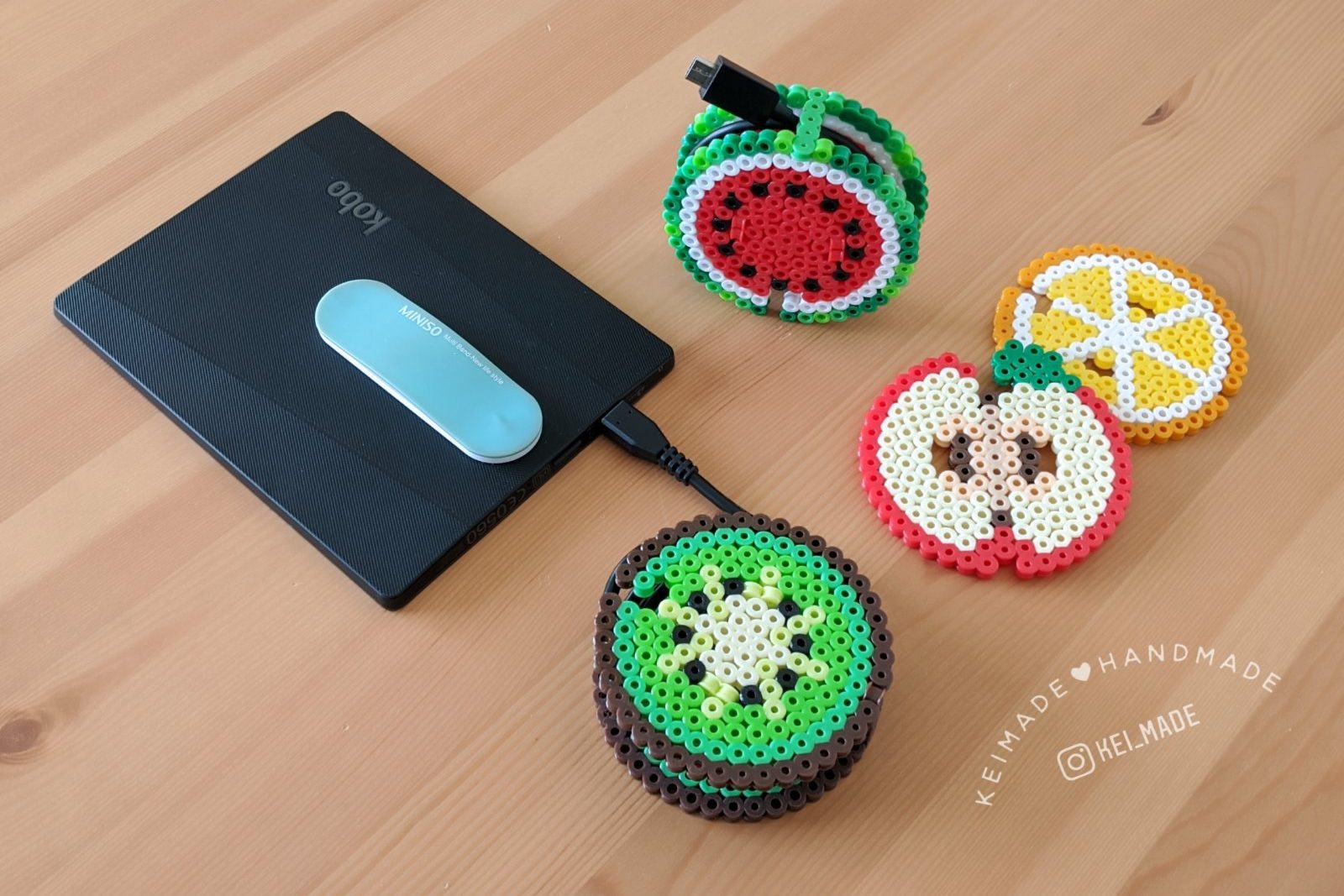 Fruit cable organisers made with Perler beads - with a divided compartment to keep earbuds clean and a snap lock feature.
